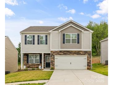 Charming two-story home with stone accents, blue shutters, and a well-manicured front lawn at 4120 Village Nw Blvd, Conover, NC 28613