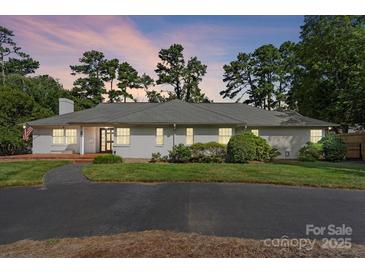 White brick ranch house with a large front yard and long driveway at 1626 S Wendover Rd, Charlotte, NC 28211