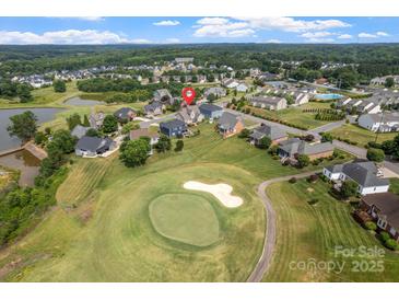 Aerial view of a neighborhood with a golf course, showcasing the property's location and surroundings at 135 Tenth Green Ct, Statesville, NC 28677