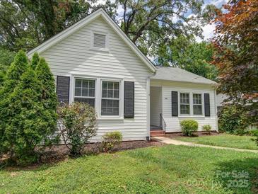 Charming white house with black shutters, landscaped lawn, and walkway at 705 Neil St, Gastonia, NC 28052