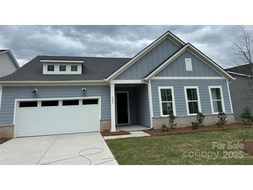Charming one-story home featuring a two-car garage and welcoming front porch at 5209 Mint Harbor Way # 0352, Charlotte, NC 28269