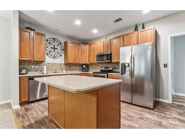 Modern kitchen with stainless steel appliances and an island at 6801 Cinnamon Cir, Mint Hill, NC 28227