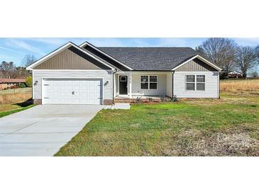 Charming single-story home with attached garage, manicured lawn, and inviting entryway at 6187 Long Branch Rd, Salisbury, NC 28147