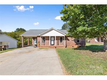 Charming single-story brick home featuring a covered carport and inviting front porch at 927 Kearney Dr, Shelby, NC 28152