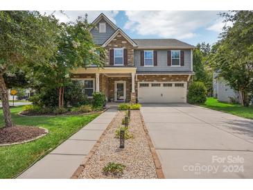 Two-story home with stone accents and a landscaped front yard at 4043 Orchid Way, Tega Cay, SC 29708