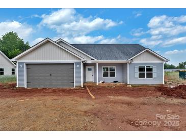 New construction home featuring light gray siding, a two-car garage, and a classic roof design at 6217 Long Branch Rd, Salisbury, NC 28147