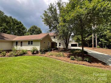 House exterior showcasing landscaping and a detached garage at 4300 Daniel Dr, Waxhaw, NC 28173