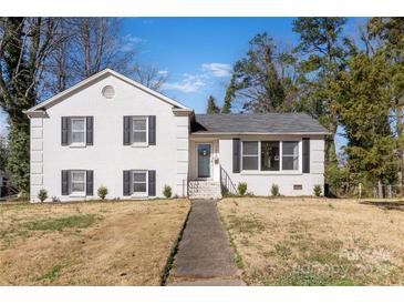 Charming white brick two-story home with black shutters and well-maintained front lawn at 1628 Shannonhouse Dr, Charlotte, NC 28215