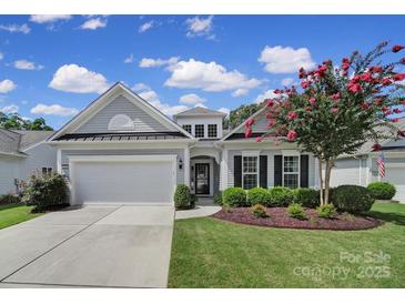 Charming single-Gathering home featuring a well-manicured lawn and attached two-car garage at 2105 Kennedy Dr, Indian Land, SC 29707
