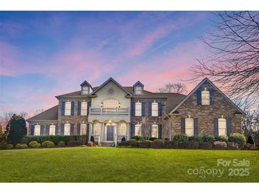 Brick front two-story home with a large front yard at 3012 Wheatfield Dr, Waxhaw, NC 28173