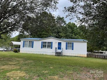 White single-wide mobile home with blue accents and a spacious yard at 6261 Burnhurst Ln, Denver, NC 28037