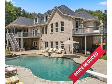 Luxury home with a beautiful pool, expansive patio, and large backyard at 8516 Mcilwaine Rd, Huntersville, NC 28078