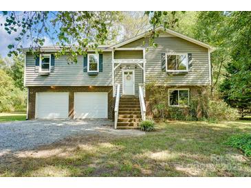 Gray two-story house with two-car garage, and landscaped yard at 5601 Indian Brook Dr, Matthews, NC 28104