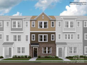 Three-story townhome with brick and siding exterior, multiple windows, and a front door at 4062 Skyboat Cir, Fort Mill, SC 29715