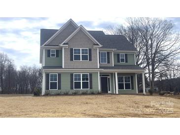 Two-story house with green and gray siding, and a covered front porch at 822 N Rocky River Rd, Monroe, NC 28110