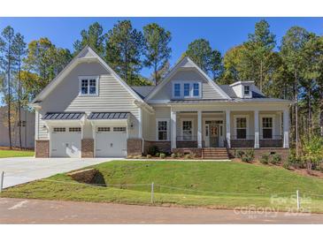 Two-story house with a front porch, two-car garage, and nicely landscaped yard at 1025 Patterson Farm Rd, Mooresville, NC 28115
