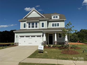Charming two-story home with attached garage, landscaped yard, and Craftsman-style details at 4808 Glen Stripe Dr # Cal0036, Indian Trail, NC 28079