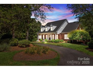 Brick home with landscaped yard and driveway at 721 Orphanage Rd, Concord, NC 28027