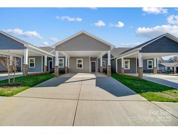 Gray exterior with covered carport and brick accents at 1523 28Th Street Se Pl, Hickory, NC 28602