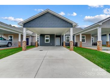 Modern craftsman style home with covered carport and well-manicured lawn at 2870 15Th Avenue Se Pl, Hickory, NC 28602