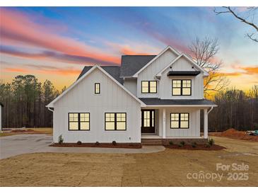 Charming two-story white home with a well-manicured lawn and beautiful sunset at 199 Heartland Dr # 10, Rock Hill, SC 29732