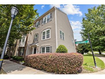 Charming two-story home featuring beautiful architectural details, manicured landscaping, and inviting curb appeal at 9341 Lenox Pointe Dr, Charlotte, NC 28273
