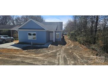 Charming light blue home with gray roof, manicured lawn, and inviting front entrance at 2280 Dale Earnhardt Blvd, Kannapolis, NC 28083