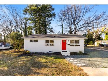 Charming ranch home with a red door and well-manicured lawn at 2600 Alleghany St, Charlotte, NC 28208