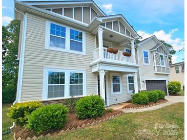 Charming two-story home showcasing a welcoming front porch and manicured landscaping at 11521 Allen A Brown Rd, Charlotte, NC 28269
