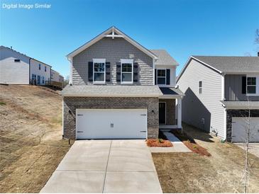 Charming two-story home with brick and shingle accents, two-car garage, and manicured lawn at 22 Porter Nw St # Sw22, Concord, NC 28027