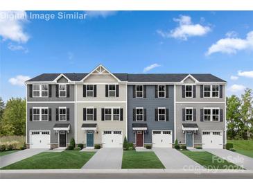 Four townhouses with attached garages and front yards at 5235 Stevedore Way, Charlotte, NC 28269