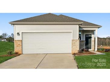 Ranch style home with a two-car garage and landscaped lawn at 730 Olde England Dr, Lincolnton, NC 28092