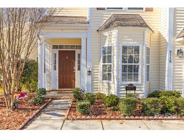 Inviting front entrance with a brown door and columns at 9718 Waltham Ct, Charlotte, NC 28269