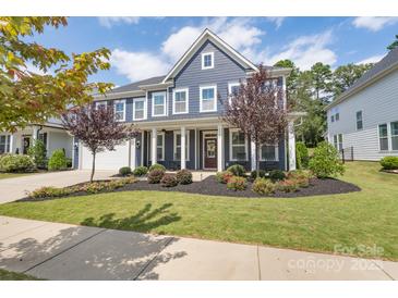 Two-story home with front porch and landscaped yard at 1180 Weir Ct, Fort Mill, SC 29708