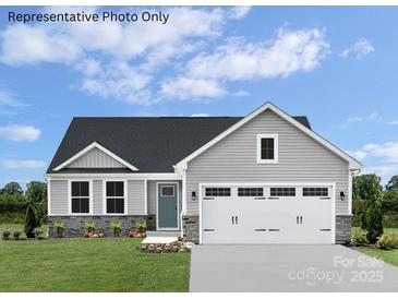 Charming single-Gathering home featuring stone accents, a two-car garage, and a well-manicured lawn at 467 Hollis Dr # 0055, Lancaster, SC 29720