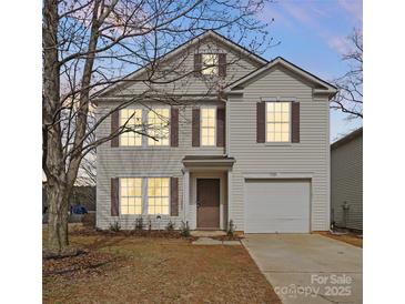 Charming two-story home with a well-maintained lawn and classic architectural details at 4242 Quinn Dr, Charlotte, NC 28269