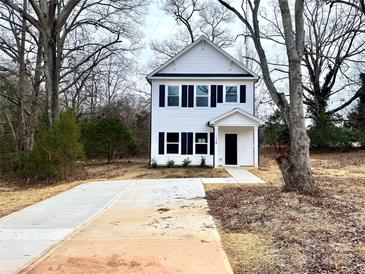 Two-story white house with black shutters and a concrete driveway at 127 Sharon Rd, York, SC 29745