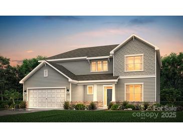 Two-story house with gray siding, three-car garage, and landscaped lawn at 1109 Grice Rd, Stanley, NC 28164