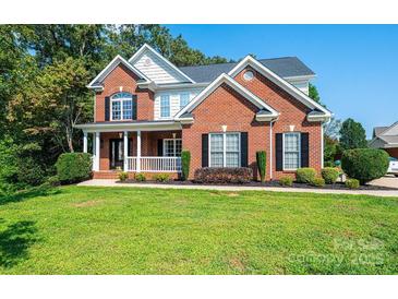 Brick two story house with a front porch and large yard at 2594 Knoll Ridge Ct, Hickory, NC 28602