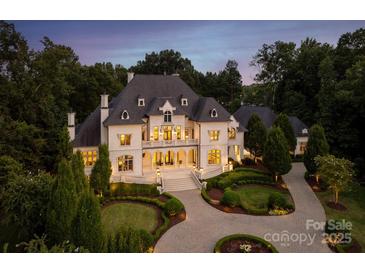 Stunning exterior view of a luxury home with manicured landscaping and a circular driveway at 423 Oakmont Ln, Waxhaw, NC 28173