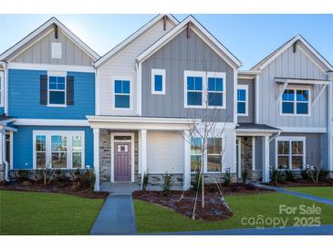 Modern townhome with blue and gray siding, and a purple front door at 10509 Boudreaux St, Huntersville, NC 28078