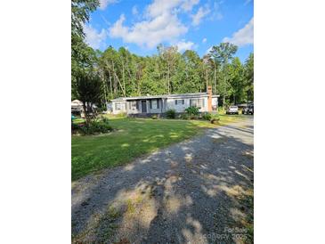 Ranch-style home with a spacious yard and mature trees at 735 Ned Marsh Rd, Salisbury, NC 28146
