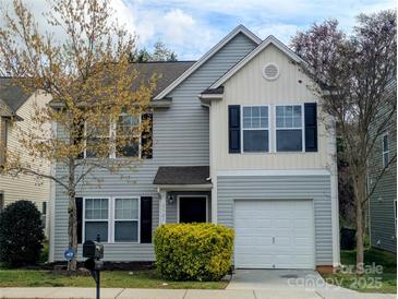 Charming two-story home featuring gray siding, black shutters, well-maintained lawn, and a one-car garage at 1327 Phil Oneil Dr, Charlotte, NC 28215