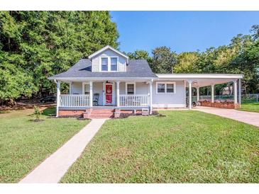 Charming single Gathering home featuring a inviting front porch and a well-maintained lawn at 60 Hunter Bridge Rd, Stony Point, NC 28678