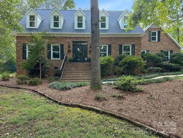 Charming brick home with dormer windows and a welcoming entrance and landscaped yard at 8503 Foxbridge Dr # 16, Matthews, NC 28104