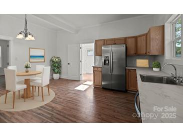 Bright kitchen boasts stainless steel appliances and wood cabinets at 225 York Ave, Kannapolis, NC 28083