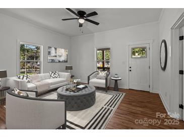 Bright living room with hardwood floors, comfy seating, and large windows at 225 York Ave, Kannapolis, NC 28083