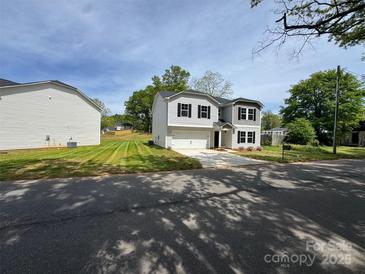 Two story home featuring manicured lawn, attached garage and covered entry at 1313 Dodd St, Shelby, NC 28152