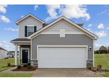 Two-story house with gray siding, a two-car garage, and landscaping at 731 Olde England Dr, Lincolnton, NC 28092