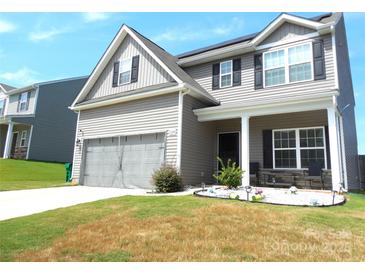 Charming two-story home with gray siding, a front porch, and a two-car garage at 1109 Creedmore Ct, Charlotte, NC 28215